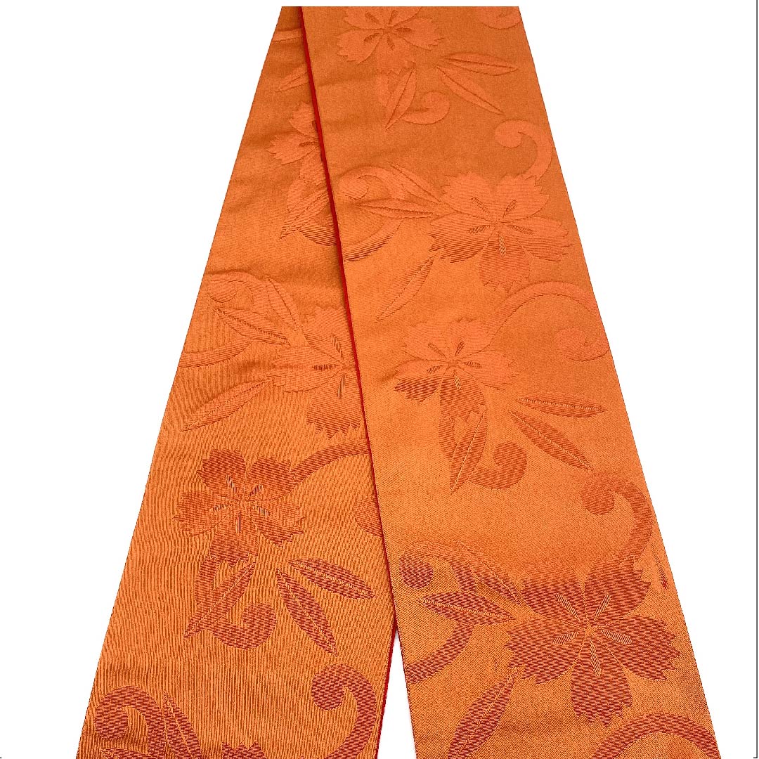 半幅帯 ポリエステル 紅鬱金色(べにうこんいろ) 撫子 花柄 矢絣 幾何学模様 古典柄 帯丈384cm 橙系 Sランク 1125001182326