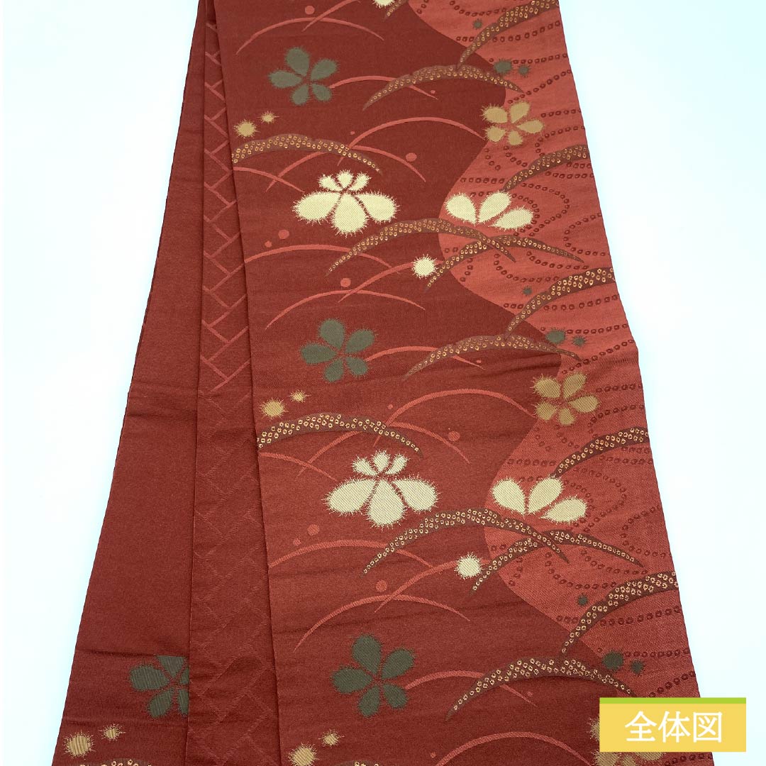 （京袋帯）名古屋帯 ポリエステル Aランク 赤銅色（しゃくどういろ） 京袋帯 露芝 花模様 帯丈364cm 六通 カジュアル 朱系 1124010653316 開き仕立て