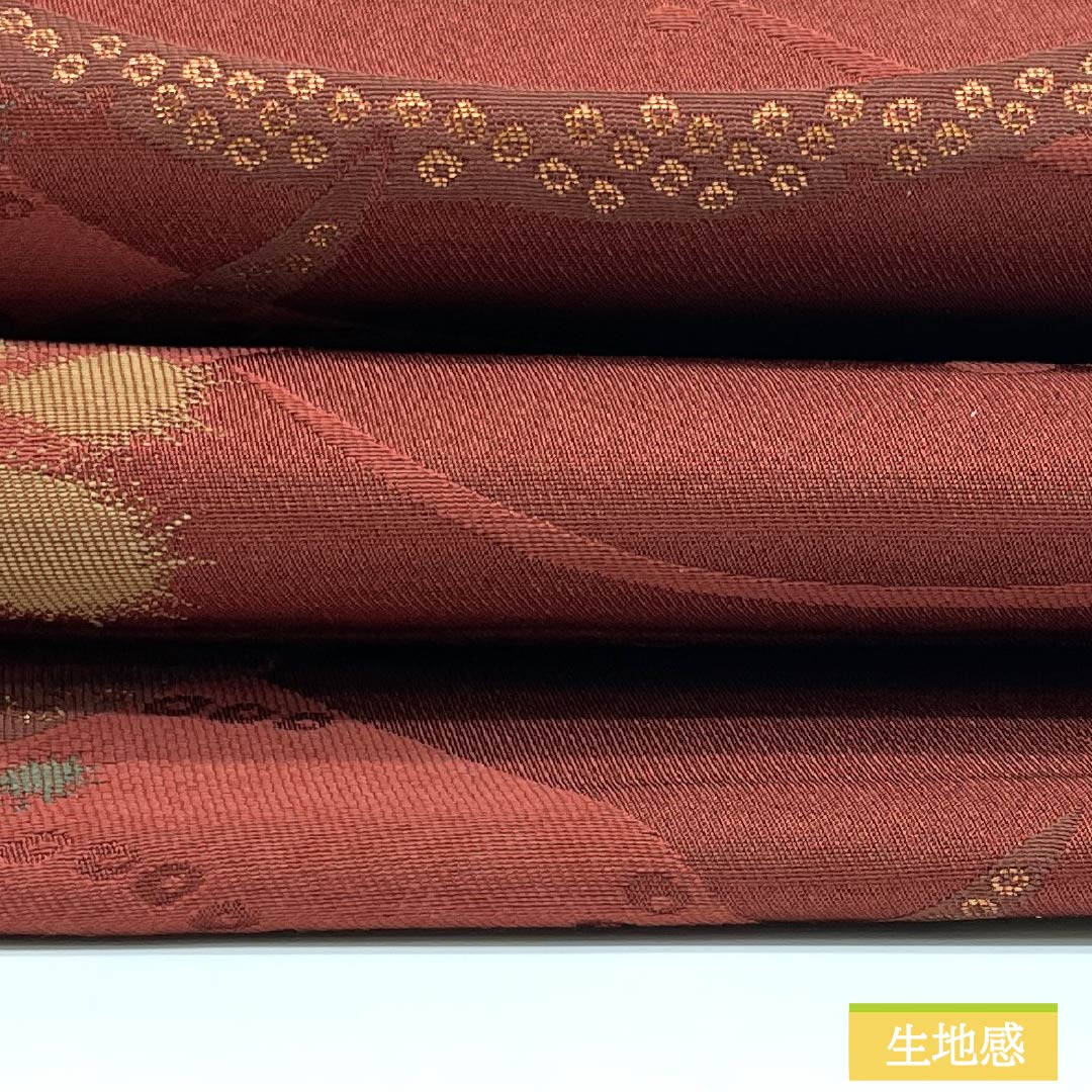 （京袋帯）名古屋帯 ポリエステル Aランク 赤銅色（しゃくどういろ） 京袋帯 露芝 花模様 帯丈364cm 六通 カジュアル 朱系 1124010653316 開き仕立て